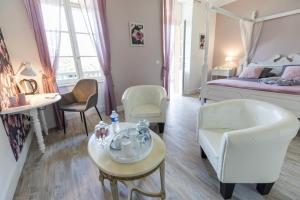 a bedroom with a bed and a table and chairs at Les rives de l'escamat in Sabres +46 photos
