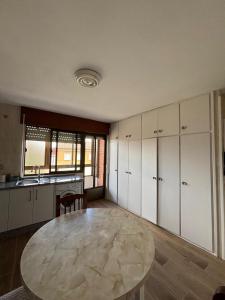 a large kitchen with a table and a counter at Casa Vazan in Laguna Dalga +5 photos