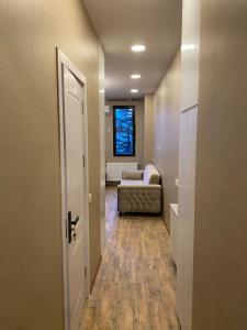 a hallway with a living room with a couch at Makhinjauri - First Line Sea View in Makhinjauri