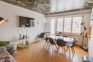 a living room with a table and chairs at Hostel by Hyve Basel in Basel