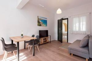 a living room with a table and a couch at Ariti Apartments in Kassiopi