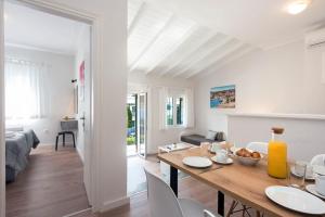 a kitchen and living room with a table and chairs at Ariti Apartments in Kassiopi