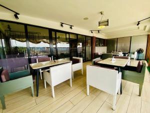 a restaurant with tables and chairs and windows at The Destination by Gidanka in Abuja +22 photos