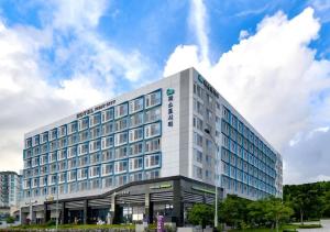 a large white building with a lot of windows at Firstcity Hotel YEOSU in Yeosu