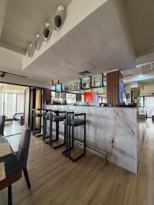 a bar with a row of stools in a room at The Destination by Gidanka in Abuja