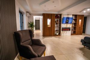 a living room with a chair and a television at Denta Suport in Râmnicu Vâlcea