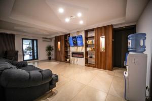 a living room with a couch and a refrigerator at Denta Suport in Râmnicu Vâlcea