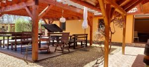 a wooden pergola with a table and chairs on a patio at Apartmány-Včelka in Trpnouze
