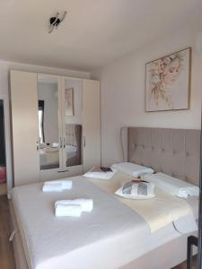 a bedroom with a large white bed and a mirror at Bliss by the Sea in Ulcinj +29 photos