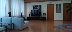 a living room with a couch and a tv at Park Hotel Galileo in Reggello
