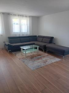a living room with a couch and a coffee table at Ferienwohnung in Arrach