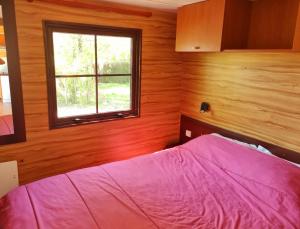 a bedroom with a bed and a window at Parc- Camping de Coullons in Coullons