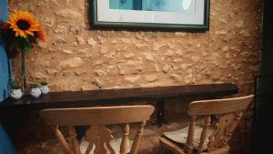 a table with two chairs and a vase with a sunflower at Bonfarto Locations in Urval +42 photos