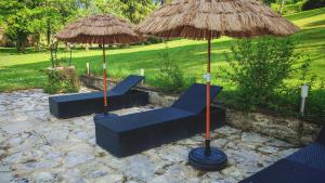 two blue chairs and umbrellas on a patio at Bonfarto Locations in Urval