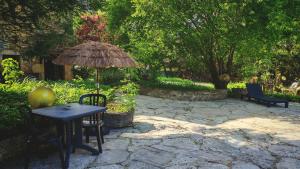 a patio with a table and an umbrella at Bonfarto Locations in Urval