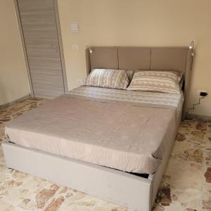 a large bed in a bedroom with a large mattress at FREE HOUSE in Palmi