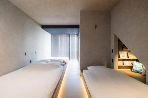 a row of beds in a room at nagisa awajishima in Awaji