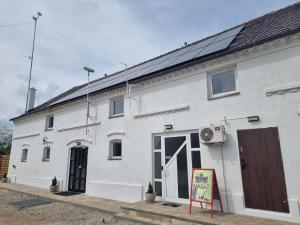 a white building with a solar panel on it at Orzechowy Dom in Trzebnica