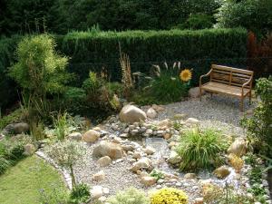 a bench sitting in the middle of a garden at "Haus Waldblick" in Bad Bramstedt