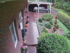 a car parked in a garage with a brick walkway at "Haus Waldblick" in Bad Bramstedt