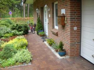 a brick house with a brick walkway next to a door at "Haus Waldblick" in Bad Bramstedt