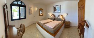 a bedroom with two beds and a window at Casa Ronda in Charco del Palo +53 photos
