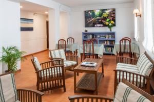 a dining room with a table and chairs and a table and chairsktop at Hotel Caleta in Lloret de Mar