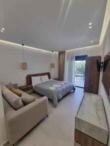 a living room with a bed and a couch at Irides Apartments in Megalochori