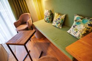 a room with a couch and a chair and a table at Ferienanlage Kirchzarten in Kirchzarten