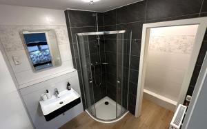 a bathroom with a shower and a sink at Hotel Schlossberg in Meißen +38 photos