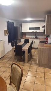 a kitchen with a table and chairs in a room at Haus in Roth an der Our in Roth