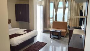a hotel room with a bed and a chair at The Bliss Hotel and Restaurant in Gangtok