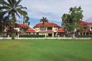 a large house with red roofs and a green yard at Laguna Fairway 3B villa-golf view in Laguna Phuket