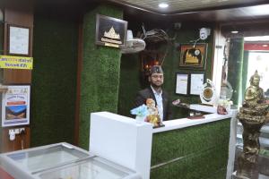 a statue of a man on a green wall at Green Valley Hotel - Srinagar in Srīnagar