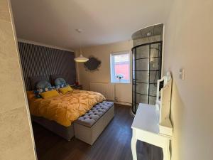 a bedroom with a bed and a desk and a window at Sunset at Horizon in Castel
