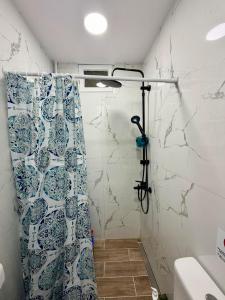 a bathroom with a shower with a shower curtain at Domi's Cottage in Agia Triada +6 photos