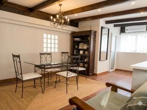 a dining room with a glass table and chairs at Sierra Blanca Bungalow in Marbella