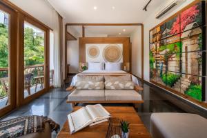 a bedroom with a bed and a couch at Harsono Boutique Resort Bali in Sanur +58 photos