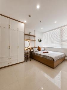 a bedroom with a bed and a large white cabinet at Nera Stay Huế - Luxury Apartment in Hue +33 photos
