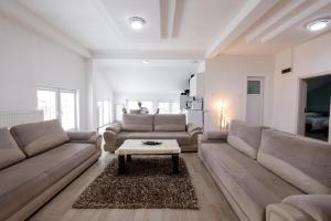 a living room with a couch and a coffee table at Premium Stay Prishtina in Prishtinë
