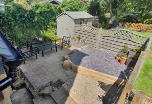 a small backyard with a bench and a fence at The Annexe At The Old Mill in Camborne