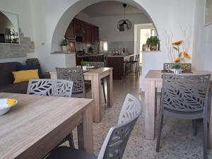 a kitchen and dining room with wooden tables and chairs at Casa rosa degli Abruzzo in Musellaro