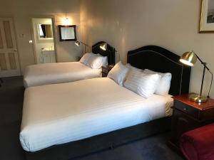 מיטה או מיטות בחדר ב-The Macquarie Hobart