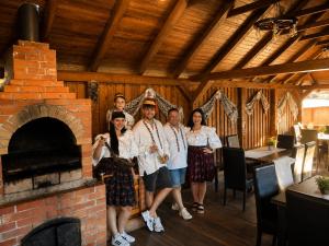 a group of people standing in front of a brick oven at Conacul Birtoc Refugiu Tradițional în Maramureș in Văleni +45 photos