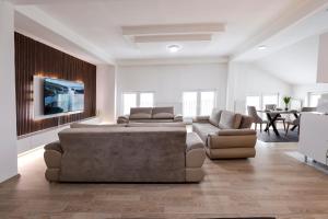 a large living room with a couch and a table at Premium Stay Prishtina in Prishtinë