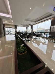 a dining room with tables and chairs in a building at الايوان برو للشقق المخدومة in Al Kharj
