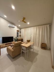 a living room with a couch and a table at De 8 Huahin in Ban Nong Chaeng