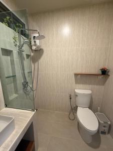 a bathroom with a shower and a toilet and a sink at De 8 Huahin in Ban Nong Chaeng +15 photos