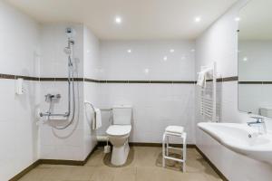 a bathroom with a shower and a toilet and a sink at Ace Hôtel Salon de Provence in Salon-de-Provence