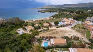 an aerial view of a house on a hill next to the ocean at Remetzo Village in Lixouri